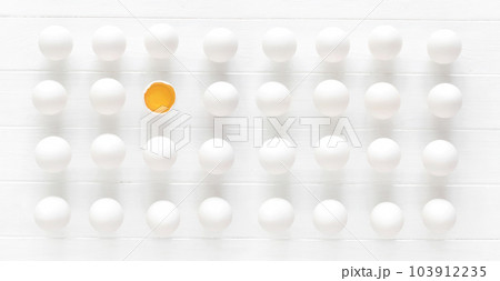 White raw eggs rows with one yolk on a white wooden table White raw eggs rows with one yolk on a white wooden table 103912235