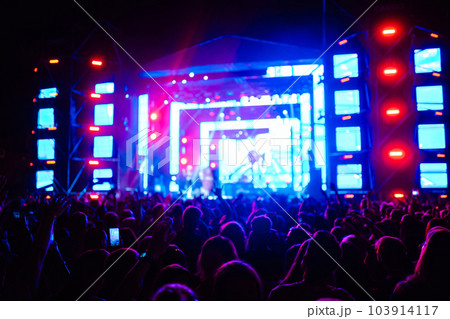 Use advanced mobile recording, fun concerts and beautiful lighting, Candid image of crowd at rock. 103914117