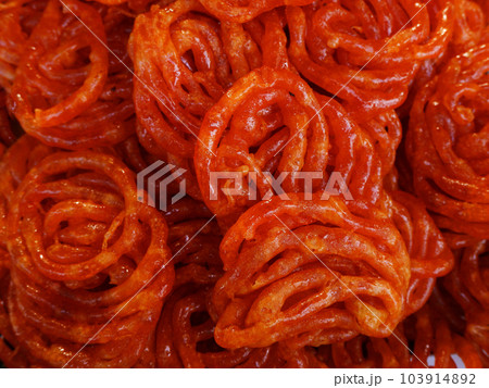 Imarti,  Amriti,  Jaangiri.  Popular Indian sweet made by deep frying lentil batter which is then soaked in cardamom and rose flavored sugar syrup, Visakhapatnam, India 103914892