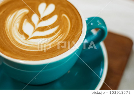 Selective focus cup of hot latte art coffee on wooden table 103915375