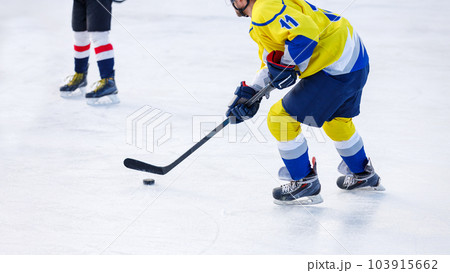 Hockey player with puck on the rink. Image with copyspace Hockey player with puck on the rink. Image with copyspace 103915662