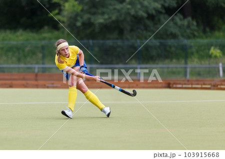 Field hockey player making pass to a teammate Field hockey player making pass to a teammate 103915668