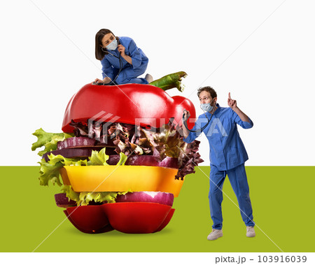 Doctors using stethoscope. Burger made from fresh healthy vegetables. Eating vitamins and following vegetarian life. Contemporary art collage. Doctors using stethoscope. Burger made from fresh healthy vegetables. Eating vitamins and following vegetarian life. Contemporary art collage. 103916039