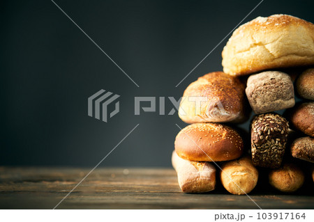 Different types of bread loaves close up with copy space. 103917164