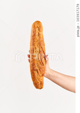 Baguette bread in woman hand over white background Baguette bread in woman hand over white background 103917179