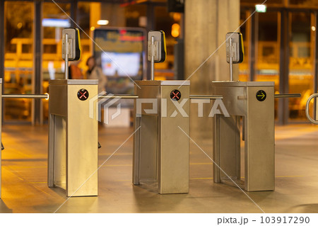 Access turnstiles from the subway in the late evening - LED-lighting signs in the direction of the passage Access turnstiles from the subway in the late evening - LED-lighting signs in the direction of the passage 103917290
