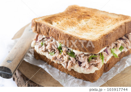 Tuna sandwich with mayo and vegetables isolated on white background Tuna sandwich with mayo and vegetables isolated on white background 103917744