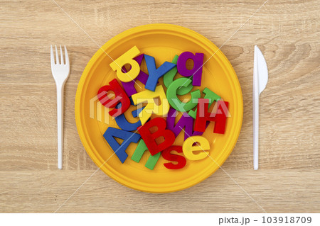 Fork, knife and plate with colored letters 103918709