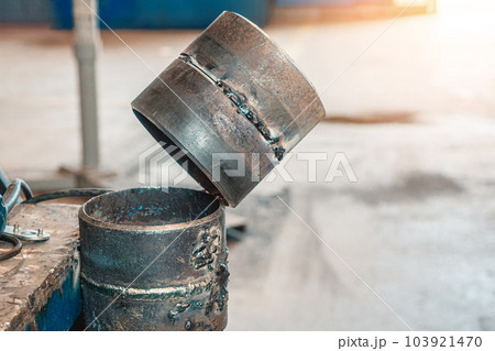 Simulator for practicing welding of metal pipes. Welded seam on metal rings. Industrial background. Simulator for practicing welding of metal pipes. Welded seam on metal rings. Industrial background. 103921470