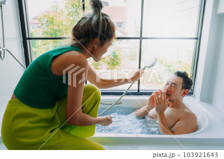 Funny playful asian couple lover play in the bathtub in the bathroom. 103921643