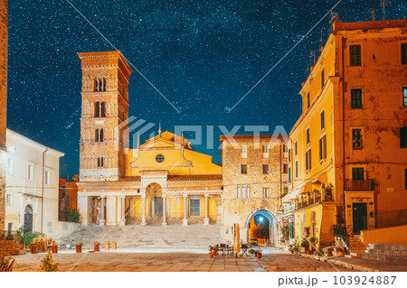 Terracina, Italy. Bold Bright Blue Night Starry Sky With Glowing Stars Above Tower Of Cathedral Of San Cesareo In Night Time. It Built On Podium Of Temple Of Roma And Augustus. Travel To Italy Terracina, Italy. Bold Bright Blue Night Starry Sky With Glowing Stars Above Tower Of Cathedral Of San Cesareo In Night Time. It Built On Podium Of Temple Of Roma And Augustus. Travel To Italy 103924887