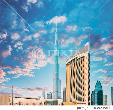 View of hotel Address Dubai Marina, Dubai mall and Burj Khalifa against dramatic sky. View of landmarks of residential district in Dubai Marina. Burj Khalifa, known as the Burj Dubai with a total 103924961