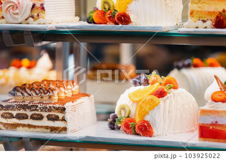 cake with strawberries, yummy assortment baked pastry in bakery. Various Different Types Of Sweet Cakes In Pastry Shop Glass Display. Good Assortment Of Confectionery. buffet with many desserts 103925022
