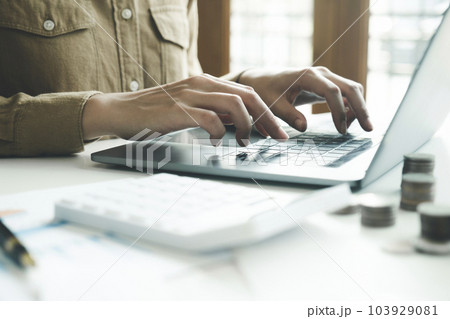 Woman accountant working on laptop computer while counting taxes online. Woman accountant working on laptop computer while counting taxes online. 103929081