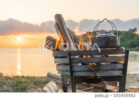 焚き火 焚き火台 キャンプファイヤー 炎 海岸 サンセット  夕日 夕焼け  キャンプギア  湯沸か 103930862
