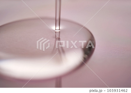 A juicy drop of gel on a purple background. 103931462