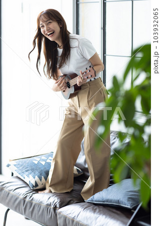 部屋でウクレレを弾く女性 部屋でウクレレを弾く女性 103932065
