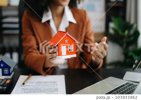 Considering buying a home, investing in real estate. Broker signs a sales agreement. agent, lease agreement, successful deal . 103933862