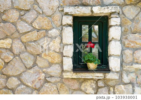 Window in old stone house with flower Window in old stone house with flower 103938001