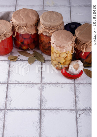 Pickled vegetables in glass jars. 103938480