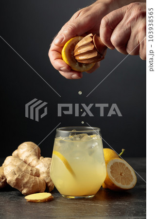 Ginger Ale with ice and lemon on a black background. 103938565