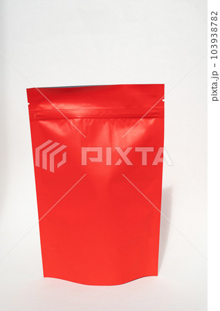 Red paper doy pack with a metallic zipper lock. Colorful matte red storage bag. Red paper doy pack with a metallic zipper lock. Colorful matte red storage bag. 103938782