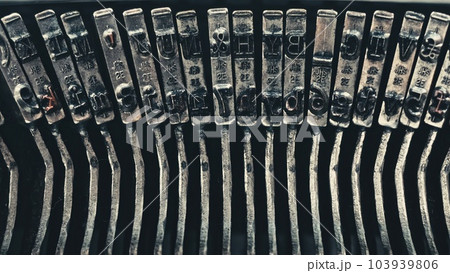 Letters and numbers on typo keys of an old manual typewriter on a retro writing machine, close up view Letters and numbers on typo keys of an old manual typewriter on a retro writing machine, close up view 103939806