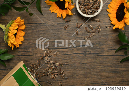 Two view of sunflower seeds and flowers on rustic wooden table. Healthy eating and snacks concept 103939819