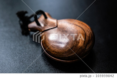 Wooden castanet for flamenco dance closeup. Traditional hispanic musical instrument for live perfomance 103939842