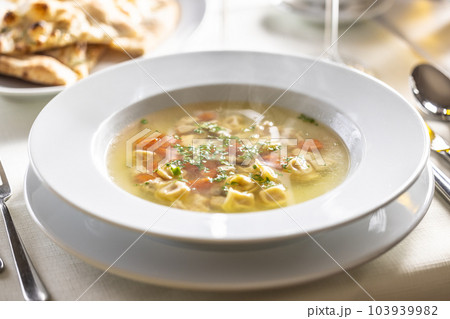 Chicken or rooster stock soup with tortellini Chicken or rooster stock soup with tortellini 103939982
