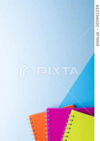 Three notebooks with binding and copy space on blue background 103941239