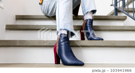 Low section of biracial transgender man wearing high heels, sitting on stairs Low section of biracial transgender man wearing high heels, sitting on stairs 103941966
