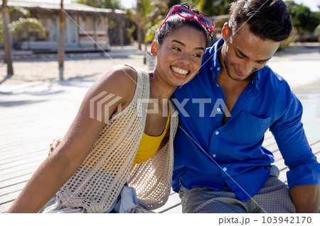 Cheerful caucasian young couple relaxing and sitting at tourist resort during sunny day Cheerful caucasian young couple relaxing and sitting at tourist resort during sunny day 103942170