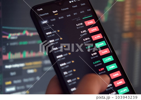 Businessman trader using smartphone checking stock exchange. Man using mobile phone with investing application. Stock market investment and trading cryptocurrency on app in hand. Online business data Businessman trader using smartphone checking stock exchange. Man using mobile phone with investing application. Stock market investment and trading cryptocurrency on app in hand. Online business data 103943239