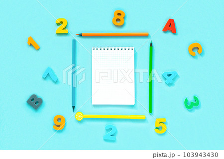 School supplies on blue background. Different stationery and letters with blank space. View from above, flat lay with space for text. Colorful Back to School concept. Elementary school. Empty notepad School supplies on blue background. Different stationery and letters with blank space. View from above, flat lay with space for text. Colorful Back to School concept. Elementary school. Empty notepad 103943430