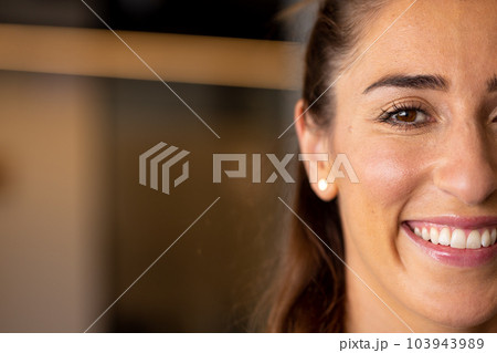 Half portrait of happy caucasian casual businesswoman with brown eyes smiling, with copy space 103943989