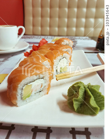 Sushi with salmon and wasabi on a white plate. Japanese and Chinese food Sushi with salmon and wasabi on a white plate. Japanese and Chinese food 103945643