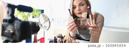 Beauty blogger shoots daily women makeup routine videos on camera Beauty blogger shoots daily women makeup routine videos on camera 103945854