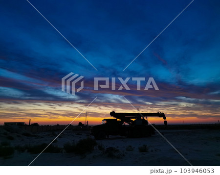 Silhouette of a Boom truck in the oilfield at sunset Silhouette of a Boom truck in the oilfield at sunset 103946053