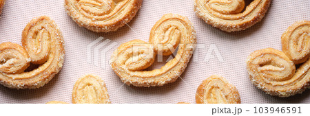 Puff pastry cookies with palms or elephant ears, caramelized and crunchy dough Puff pastry cookies with palms or elephant ears, caramelized and crunchy dough 103946591