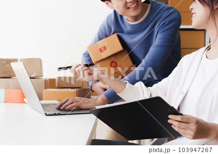 Small business owners couple entrepreneurs working with parcel, e-business, marketing, online shop, sme, entrepreneurs 103947267