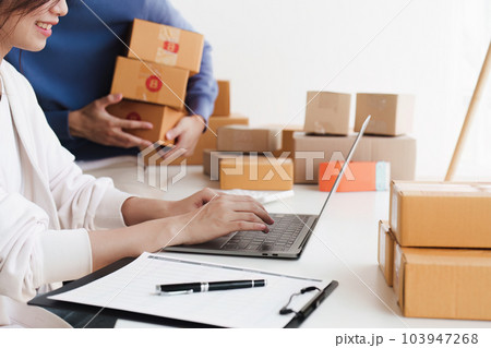 Small business owners couple entrepreneurs working with parcel, e-business, marketing, online shop, sme, entrepreneurs 103947268