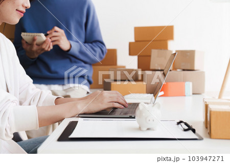 Small business owners couple entrepreneurs working with parcel, e-business, marketing, online shop, sme, entrepreneurs 103947271