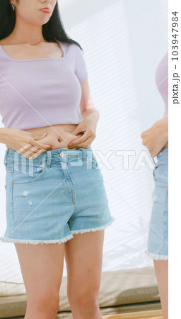 asian female pinch her belly asian female pinch her belly 103947984