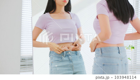 asian female pinch her belly 103948114