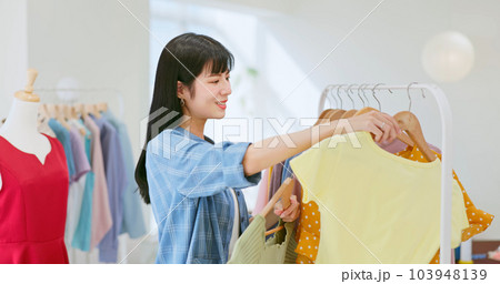 asia female choose clothes boutique 103948139