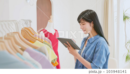 asia clerk checking clothes stock 103948141