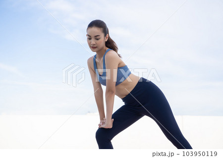 Young beauty Asian woman stretching workout outdoor rooftop. She warming up 103950119