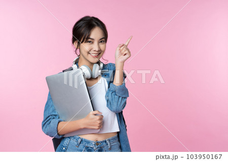 Young Asian woman texting message using mobile phone application on isolated brown background 103950167