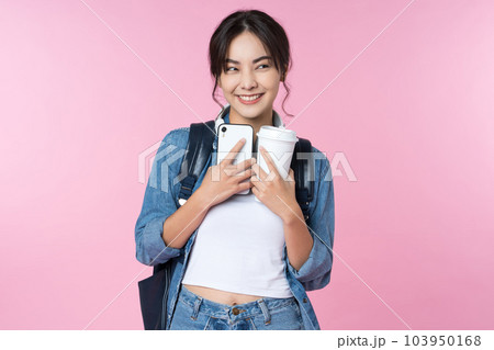 Portrait of young Asian woman student standing with smartphone coffee and backpack.College Teenager University concept. 103950168
